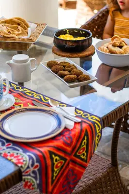 a table with plates of food on top of it at Dar Lina Guesthouse Luxor in Luxor