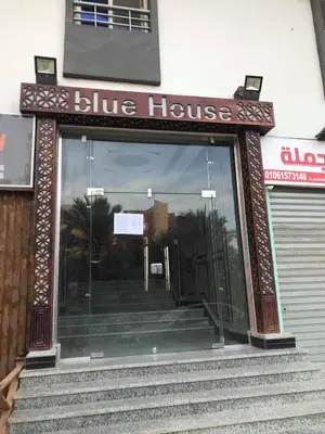 a blue house entrance with a sign on the door at Sea View Apartment at Sheraton Road 2 bed rooms in Hurghada