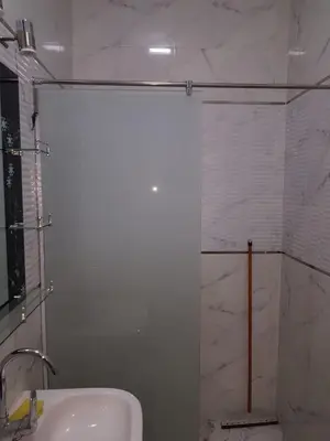 a bathroom with a shower with a sink and a shower at Bravey Apartments in Hurghada