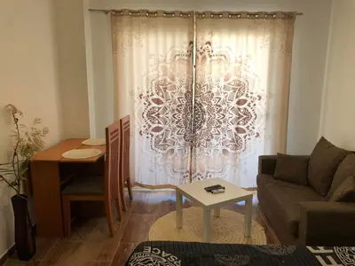 a living room with a couch and a table at Studio Florenza Khamsin in Hurghada