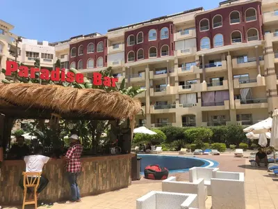 a couple standing at a bar in front of a hotel at Studio Florenza Khamsin in Hurghada