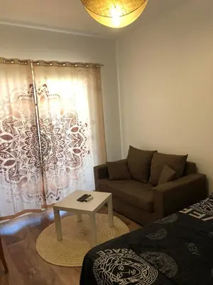 a living room with a couch and a table at Studio Florenza Khamsin in Hurghada