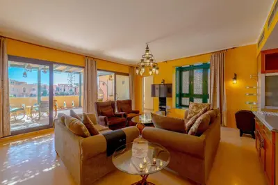 a living room with two couches and a table at VESTA - El Gouna Residence in Hurghada