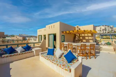a patio with chairs and a table on a roof at VESTA - El Gouna Residence in Hurghada