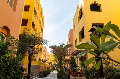 a street with yellow buildings and a street light at Al Dora Resort Hurghada in Hurghada