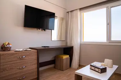 a room with a desk and a tv on the wall at Al Dora Resort Hurghada in Hurghada