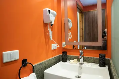 an orange bathroom with a sink and a mirror at Al Dora Resort Hurghada in Hurghada
