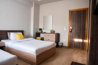 a bedroom with two beds and a wooden door at Al Dora Resort Hurghada in Hurghada
