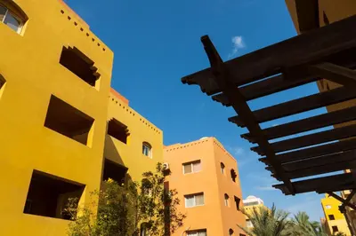a yellow building with a blue sky in the background at Al Dora Resort Hurghada in Hurghada