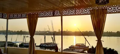 a view of a harbor with boats in the water at Senmut Luxory Apartments in Luxor
