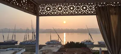 a view of a harbor with boats in the water at Senmut Luxory Apartments in Luxor