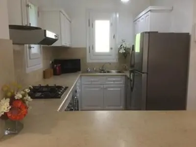 a kitchen with a stainless steel refrigerator and a sink at Villa - Sleeps 6 - Heated Pool - Garden - Parking in Hurghada