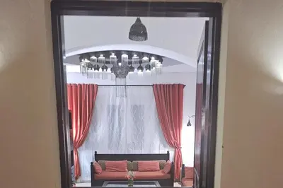 a living room with a chandelier and a couch at Villa - Sleeps 6 - Heated Pool - Garden - Parking in Hurghada