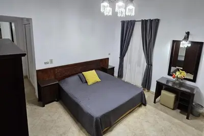 a bedroom with a bed and a vanity and a mirror at Villa - Sleeps 6 - Heated Pool - Garden - Parking in Hurghada