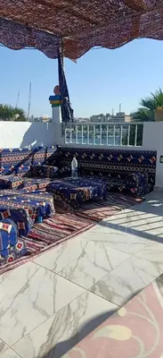 a group of blue benches on a basketball court at Nuba Tod Abouda Guest House in Aswan
