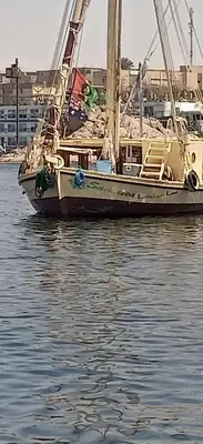 a boat sitting in the water in a harbor at Nuba Tod Abouda Guest House in Aswan