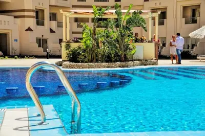 a pool at a hotel with people standing around it at Apartment I in Florenza Khamsin in Hurghada