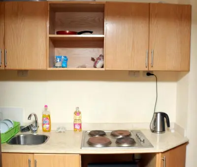 a kitchen counter with a sink and a stove at Apartment F in Florenza Khamsin in Hurghada