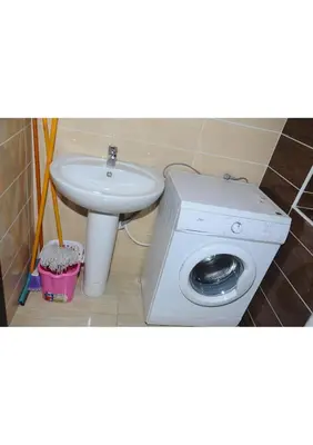 a bathroom with a sink and a washing machine and a toilet at Apartment G in Florenza Khamsin in Hurghada