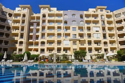 a large building with a pool in front of it at Studio H in Florenza Khamsin in Hurghada