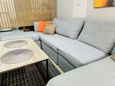 a living room with a couch and two tables at Solider Dali in Hurghada