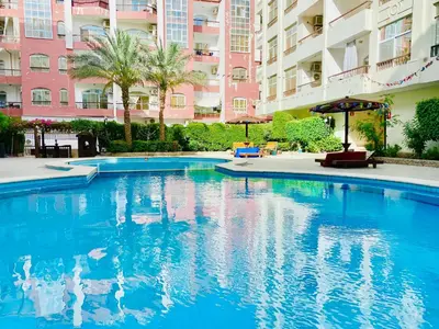 a large swimming pool in front of a building at Solider Dali in Hurghada