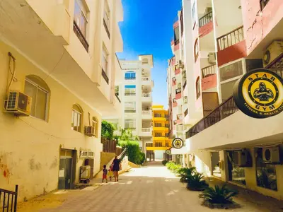 an empty street in a city with buildings at Solider Dali in Hurghada