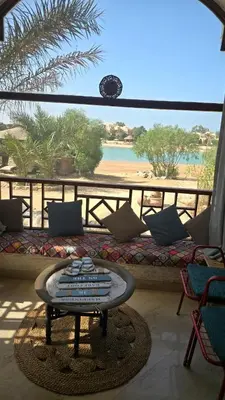 a patio with a couch and a view of the beach at chalet in nubian villas , behind Rihanna hotel in Hurghada