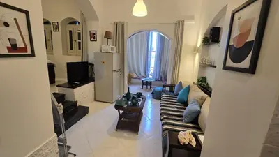 a living room with a couch and a tv at chalet in nubian villas , behind Rihanna hotel in Hurghada