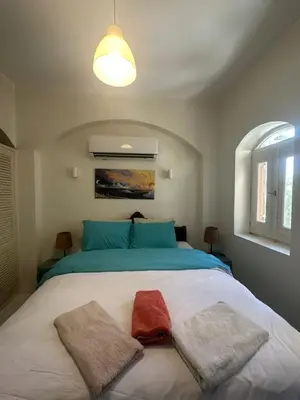 a bedroom with a bed with two towels on it at chalet in nubian villas , behind Rihanna hotel in Hurghada