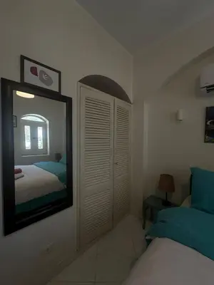 a bedroom with a mirror and a bed in it at chalet in nubian villas , behind Rihanna hotel in Hurghada
