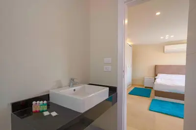 a bathroom with a sink and a bed at Arena Beach Resort & premium suits in Hurghada