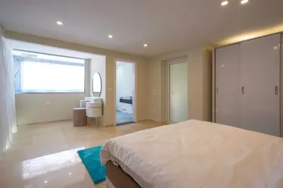 a bedroom with a large bed and a large window at Arena Beach Resort & premium suits in Hurghada