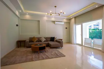 a living room with a couch and a table at Arena Beach Resort & premium suits in Hurghada