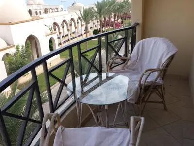 a table and chairs on a balcony with a view at Beachfront Cozy One Bedroom apartment Sahl Hasheesh Palma de Piazza in Hurghada