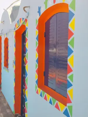 an orange window and a colorful wall at NeNeKaTo Nubian House in Aswan