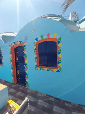 a play house with a window in a room at NeNeKaTo Nubian House in Aswan