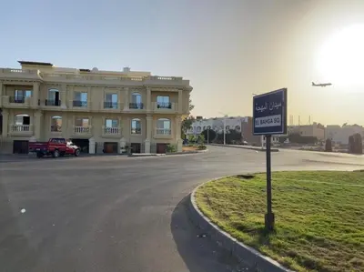 a sign in front of a large building with an airplane at Bahga Palace 4 Residential Apartments in Hurghada