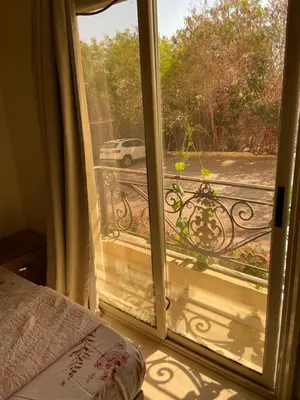 a door to a balcony with a view of a street at Bahga Palace 5 Residential Apartments in Hurghada