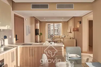 a kitchen and living room with a glass table at Mangroovy Residence El Gouna - Grovin in Hurghada