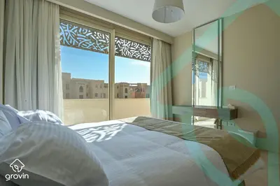 a bedroom with a bed and a large window at Mangroovy Residence El Gouna - Grovin in Hurghada