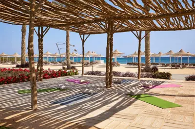 a group of people doing yoga on the beach at JAZ Costa Mares- Adults Friendly 16 Years Plus in Marsa Alam City