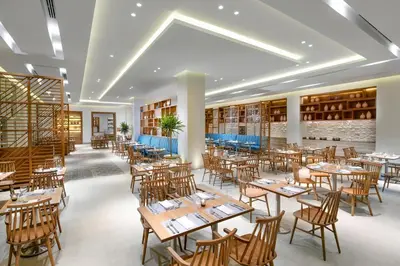 a restaurant with wooden tables and chairs at JAZ Costa Mares- Adults Friendly 16 Years Plus in Marsa Alam City