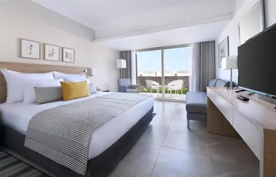 a hotel room with a bed and a television at JAZ Costa Mares- Adults Friendly 16 Years Plus in Marsa Alam City