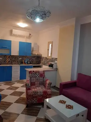 a living room with a couch and a table at apartman Sheraton plaza 419 in Hurghada