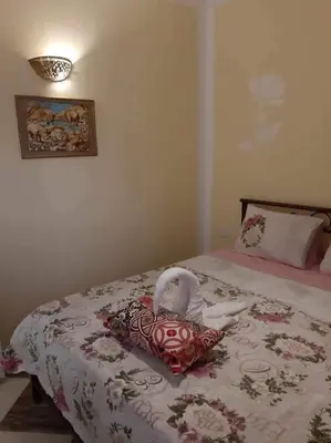 a bedroom with a bed with a doll on it at apartman Sheraton plaza 419 in Hurghada