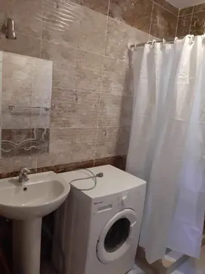 a bathroom with a white toilet and a sink at apartman Sheraton plaza 419 in Hurghada