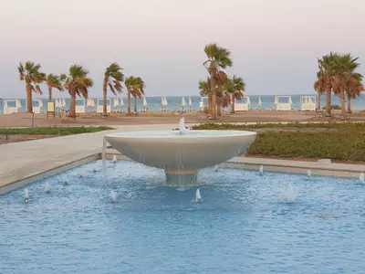 a fountain in the water in front of the beach at luxury apartment at Mangroovy El Gouna in Hurghada
