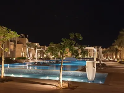 a view of a swimming pool at night at luxury apartment at Mangroovy El Gouna in Hurghada