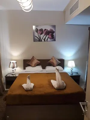 two swans sitting on a bed in a bedroom at luxury apartment at Mangroovy El Gouna in Hurghada